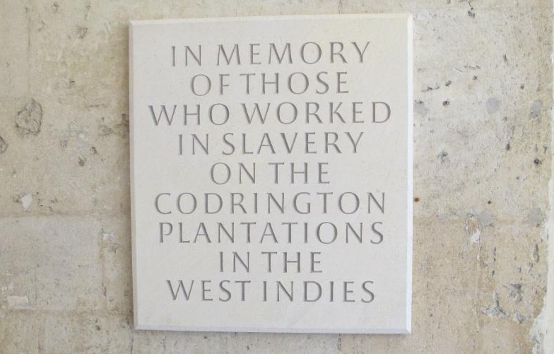 Memorial plaque: "IN MEMORY OF THOSE WHO WORKED IN SLAVERY ON THE CODRINGTON PLANTATIONS IN THE WEST INDIES"